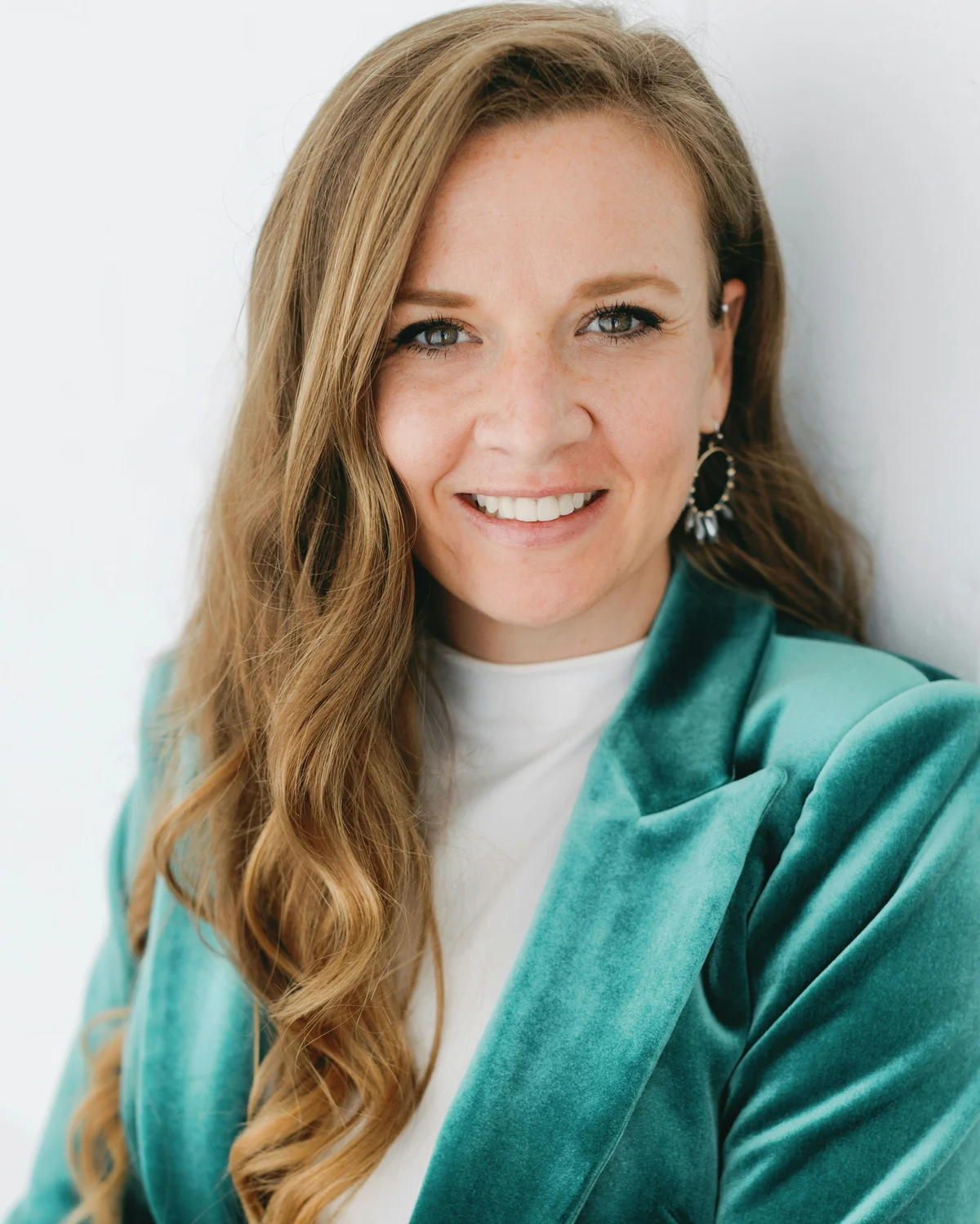 Audience portrait: woman in a teal blazer